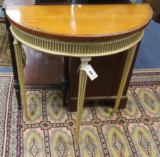 A Sheraton Revival painted and parcel-gilt satinwood demi-lune side table W.76cm